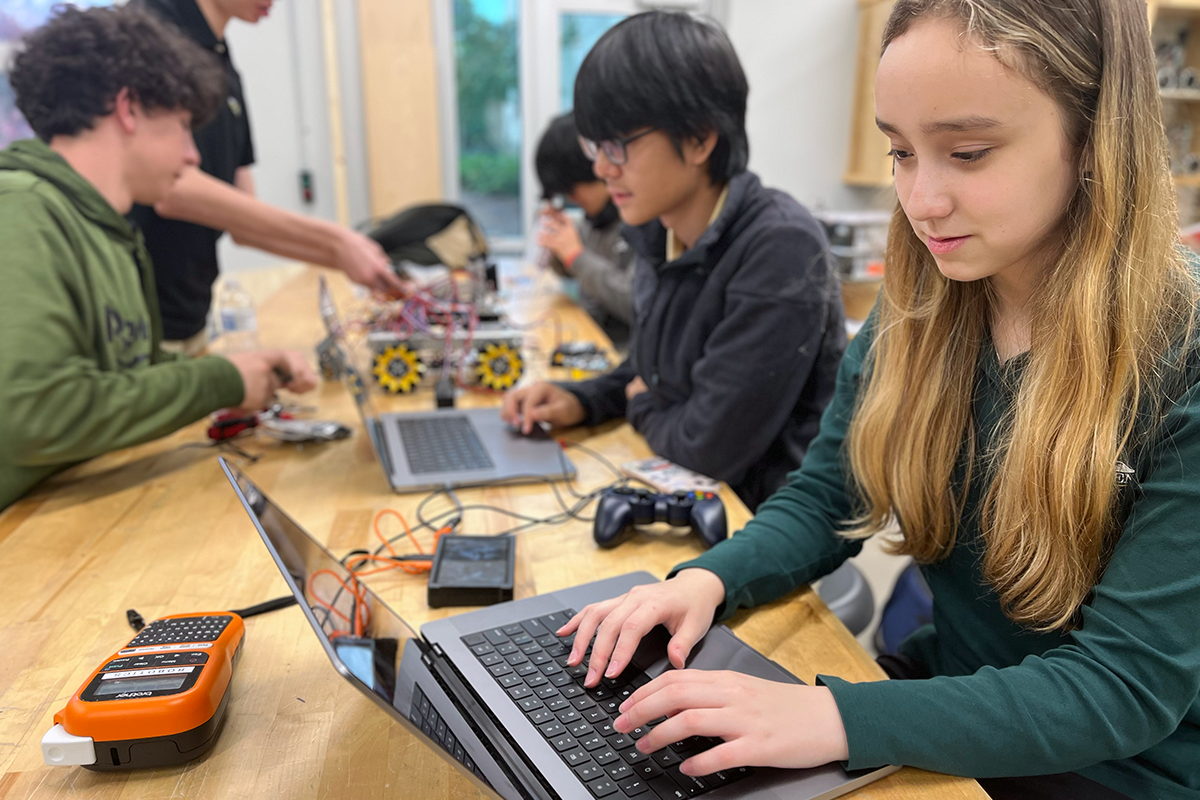Team members working on electronics and wiring