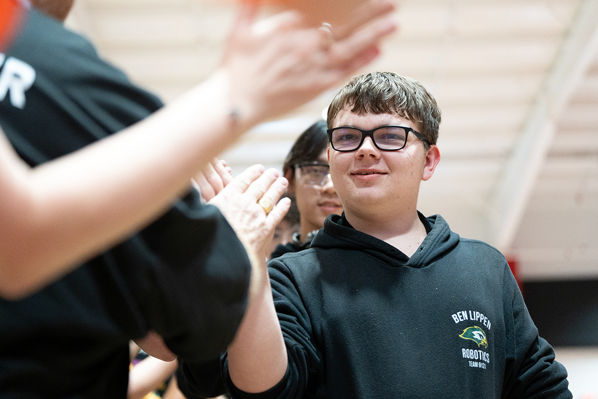 Team member high-fiving at competition