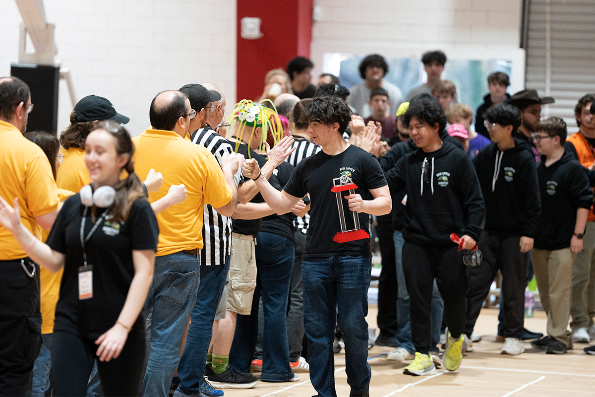 Team celebrating with trophy at competition