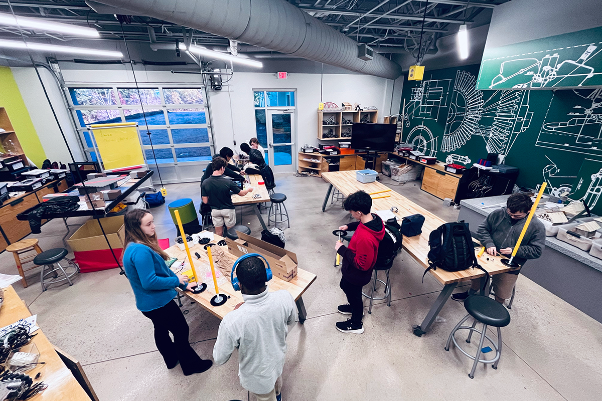 Students collaborating on robot assembly