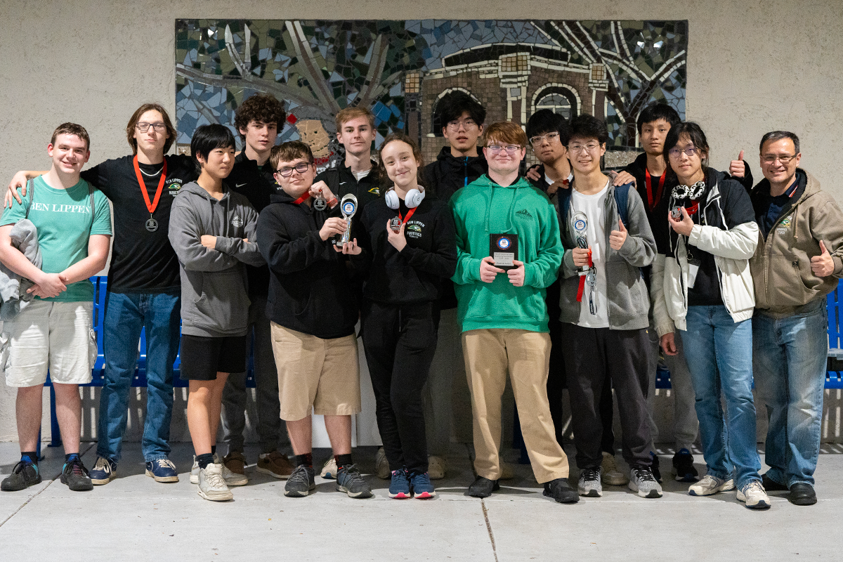 Full team group photo with awards and trophies